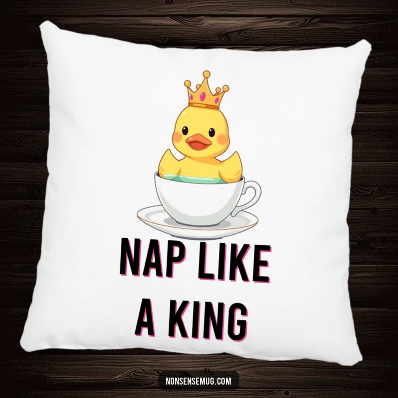 Funny crowned rubber duck floating in a teacup, depicted on a soft and humorous pillow.