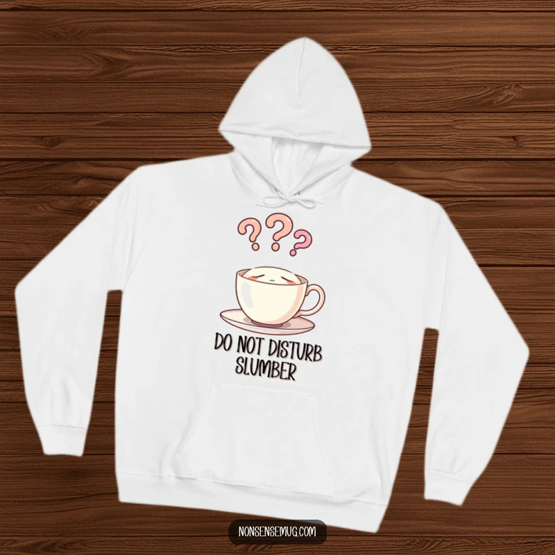 Funny and warm hoodie featuring a sleepy teacup with a steam cloud forming question marks, a comfy humorous apparel.