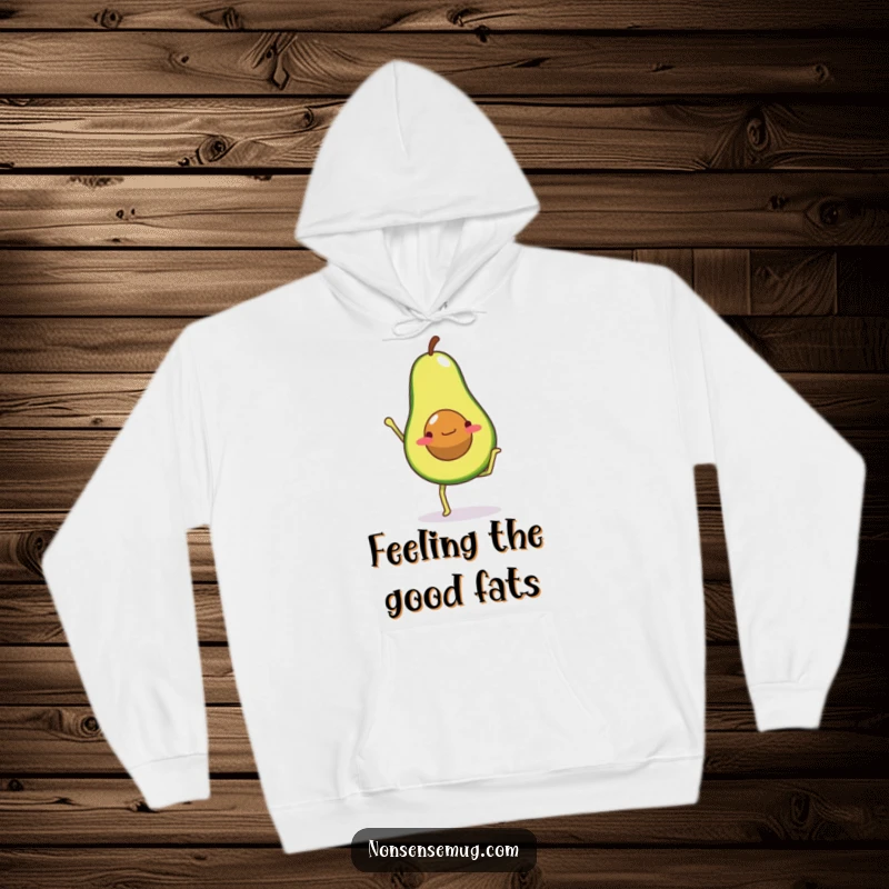 Funny hoodie printed with an avocado character with legs attempting a challenging handstand, showcasing its commitment to wellness.