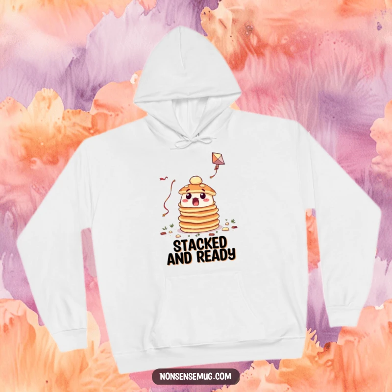 Funny hoodie featuring a surprised pile of pancakes hilariously trying to fly a kite, offering cozy humor.