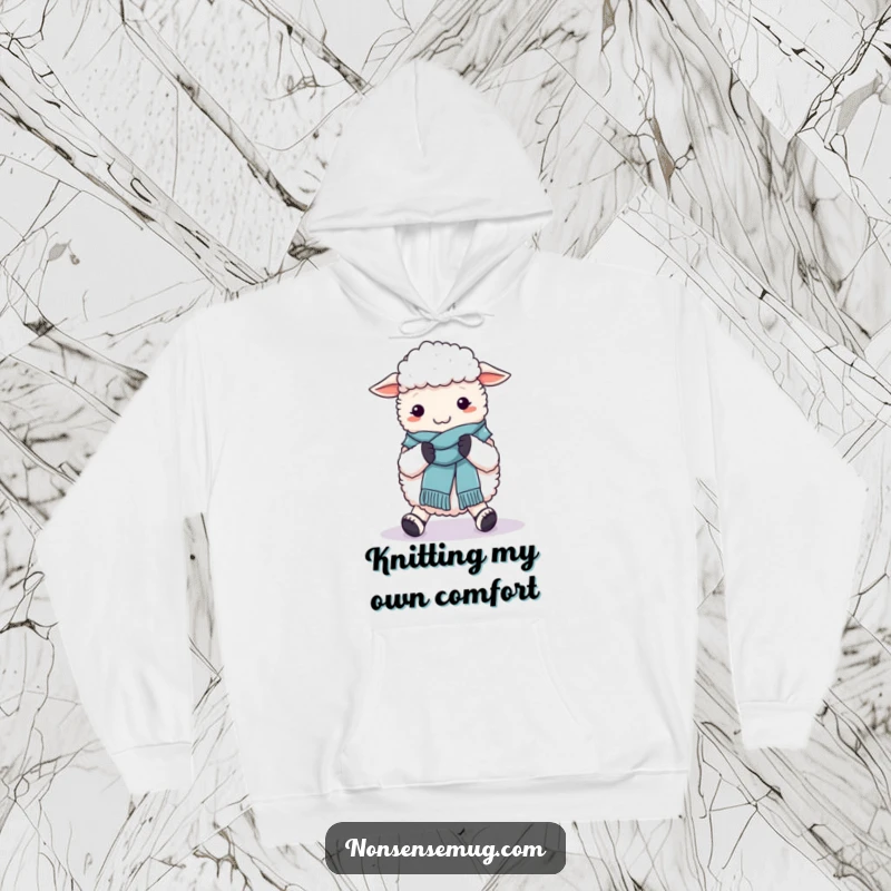 Funny hoodie featuring a fluffy sheep hilariously knitting a wool scarf around its own feet, perfect for cozy laughs.