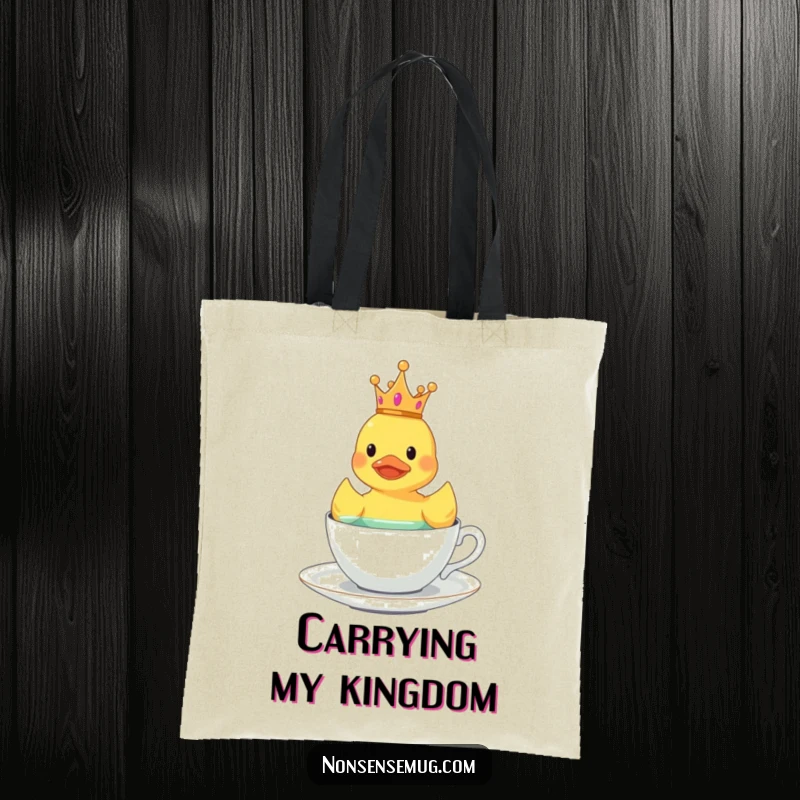 Funny rubber duck wearing a tiny crown, floating in a teacup, on a stylish tote bag.